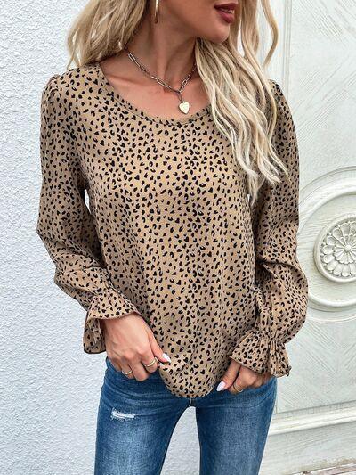 a woman wearing a leopard print top