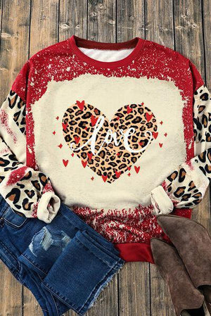 a sweater with a leopard print heart on it