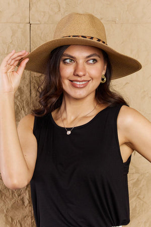 a woman in a black shirt and a brown hat