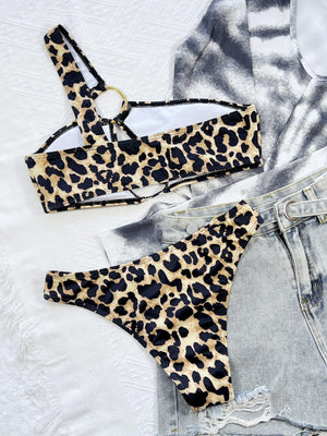 a pair of leopard print bikinisuits on a bed