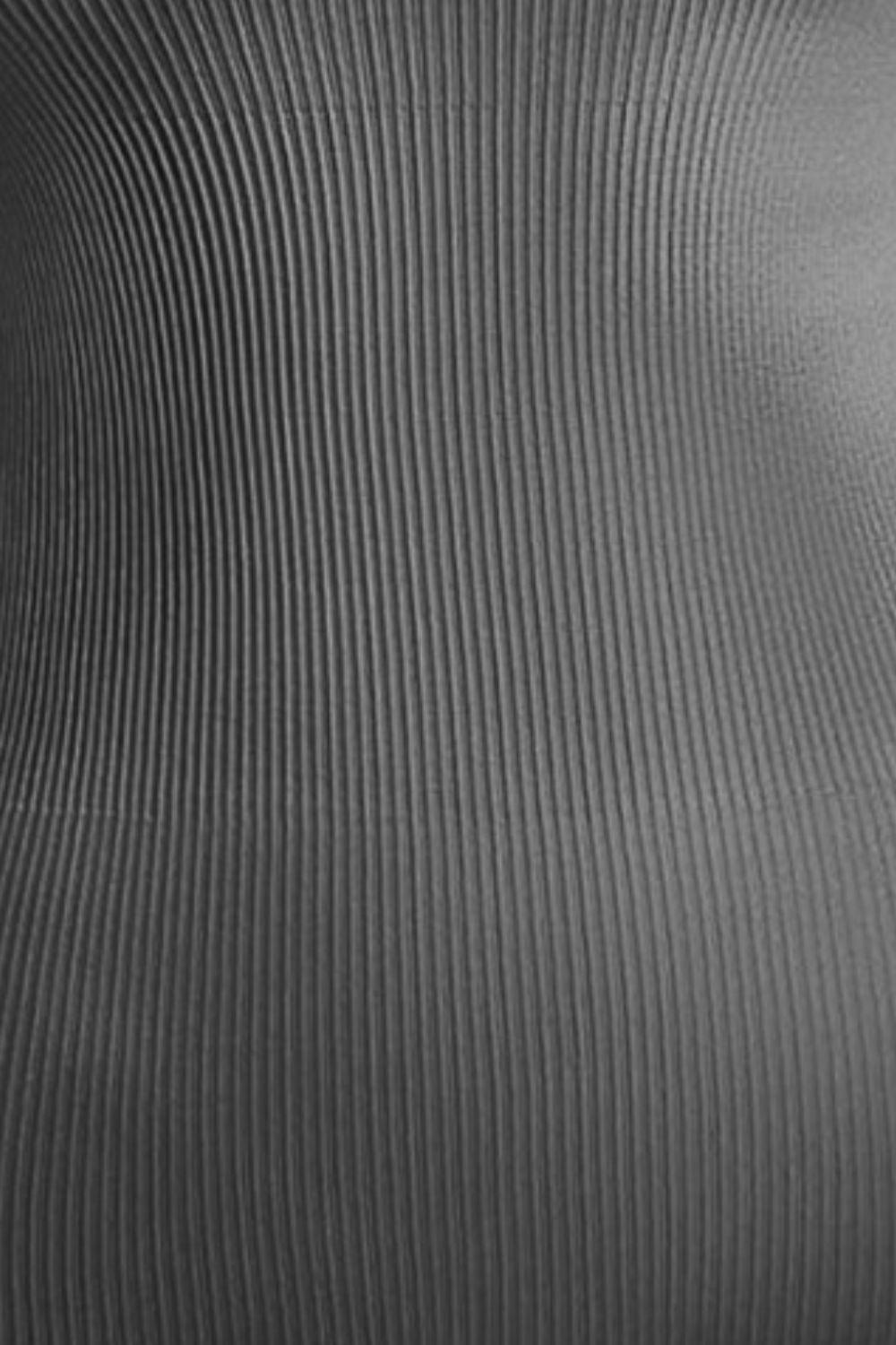 a black and white photo of a metal surface