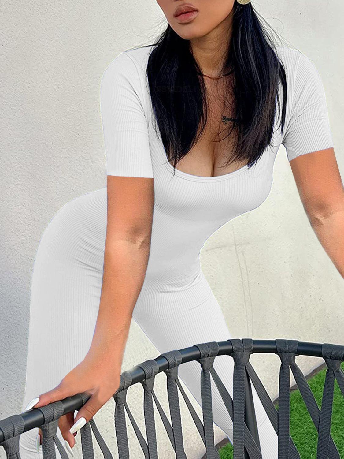 a woman in a white dress leaning on a fence