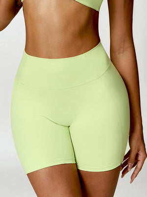 a woman in a lime green sports bra top and shorts