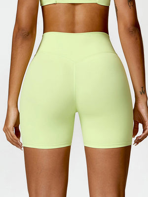 a woman in a lime green sports bra top and shorts