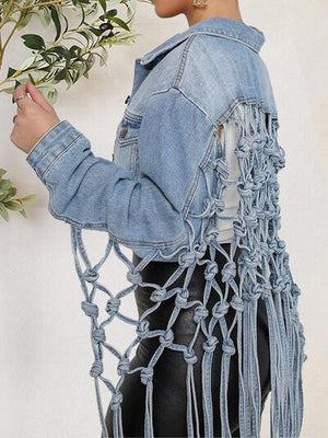 a woman in a denim jacket holding a plant