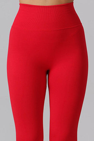 a woman in red leggings with a white bra