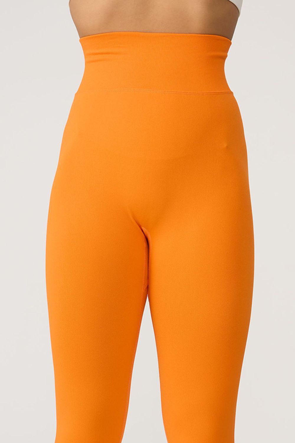 a close up of a woman's butt in an orange leggings