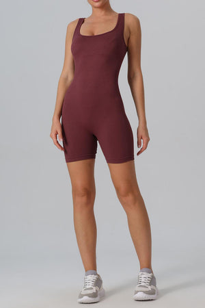 a woman in a maroon bodysuit posing for a picture