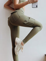 a woman in green leggings holding a cell phone