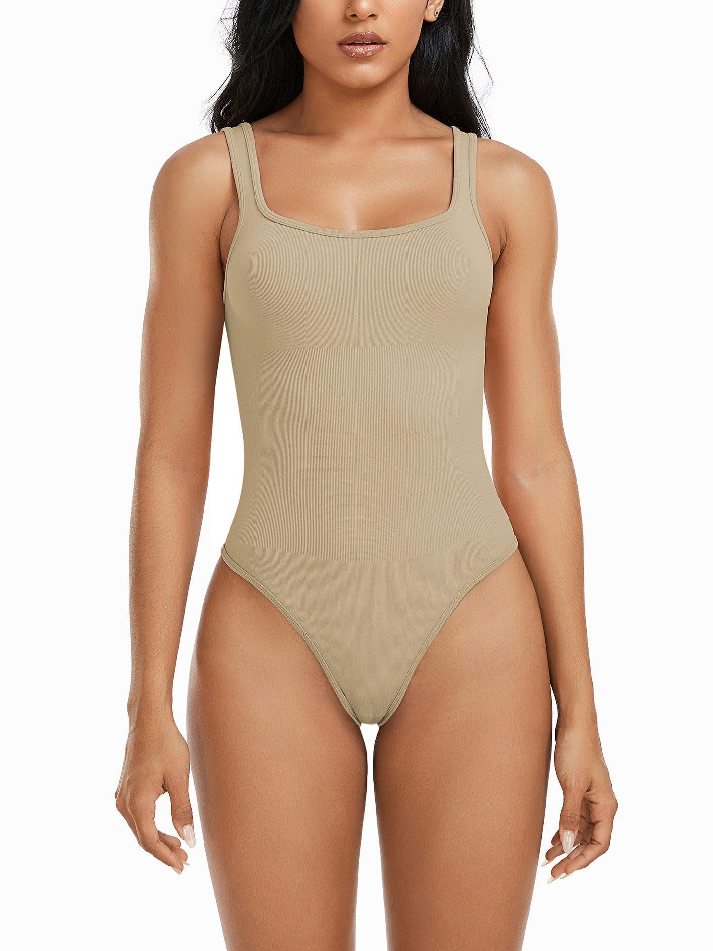 a woman in a tan bodysuit