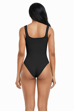 a woman in a black swimsuit back view