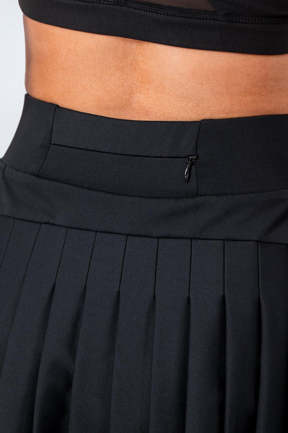 a close up of a person wearing a black skirt