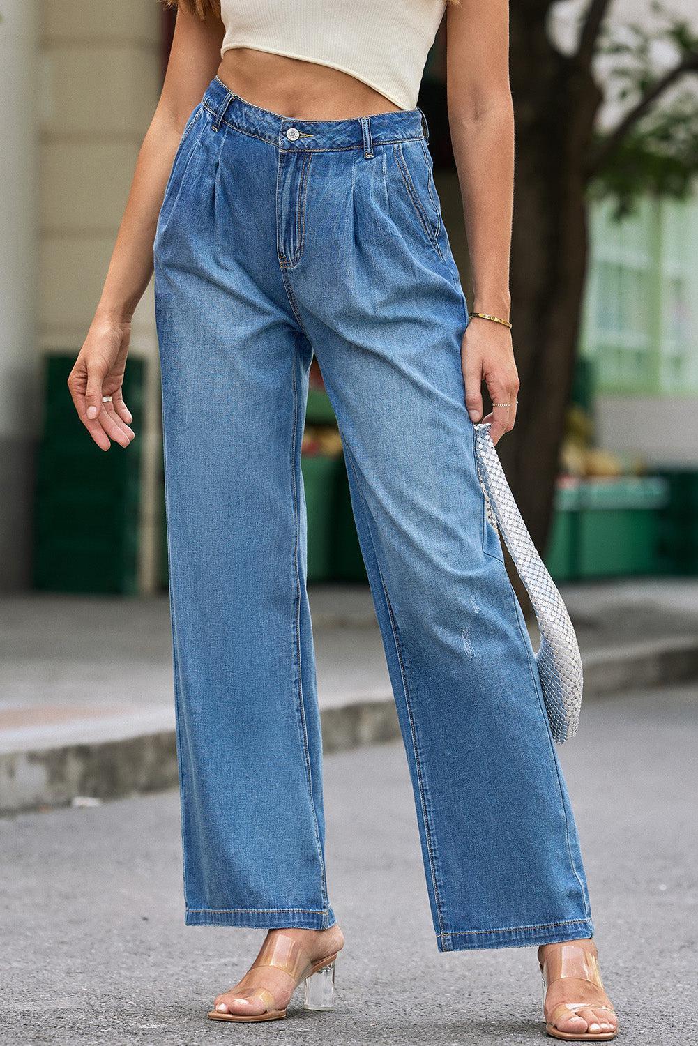 a woman wearing high waist jeans and a crop top