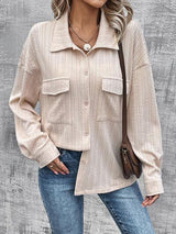 a woman wearing a beige jacket and jeans