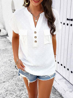 a woman wearing a white shirt and denim shorts