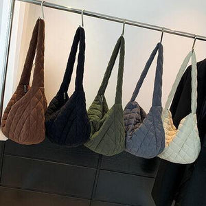 a row of purses hanging on a rack