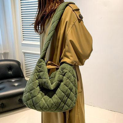 a woman carrying a green quilted purse