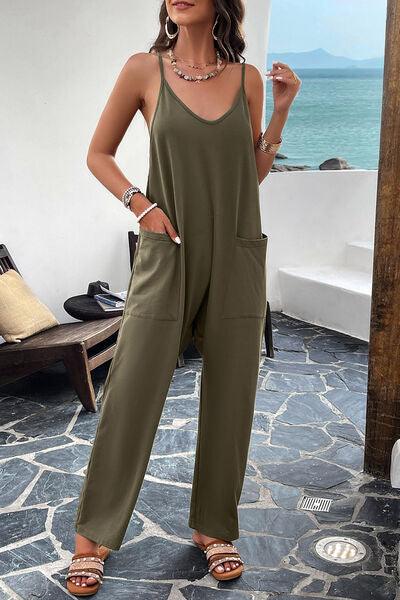 a woman in a green jumpsuit posing for a picture