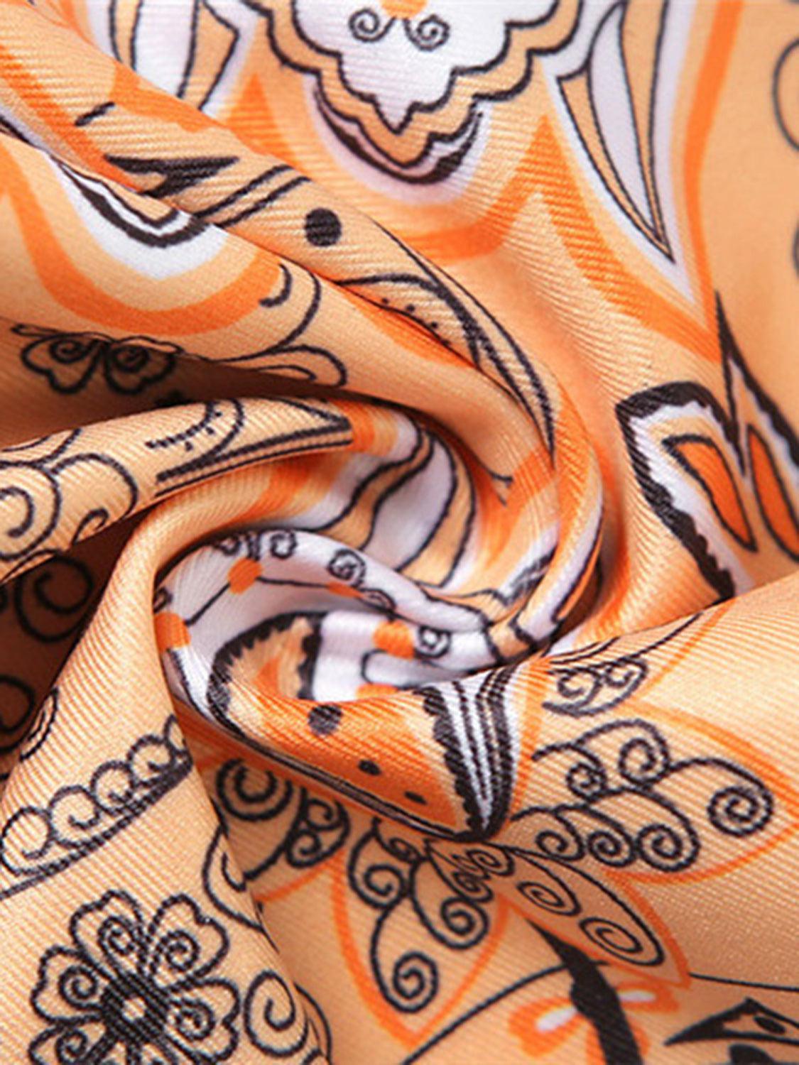 a close up of an orange and black scarf