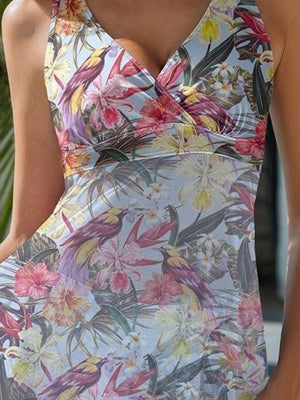 a woman wearing a dress with flowers on it