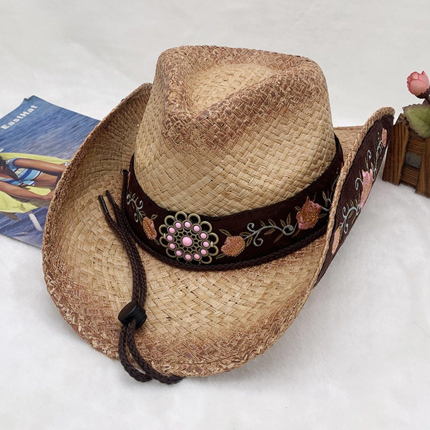 a cowboy hat with a cowgirl figure on top of it