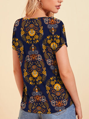 a woman wearing a top with a flower pattern