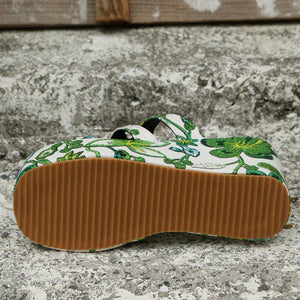 a pair of shoes sitting on top of a cement surface