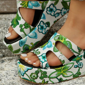 a close up of a woman's shoes with flowers on them