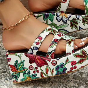 a close up of a woman's shoes with flowers on them