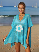 a beautiful woman standing on top of a sandy beach