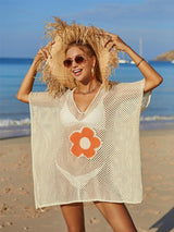 a woman standing on top of a sandy beach