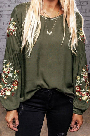 a woman with blonde hair wearing a green top