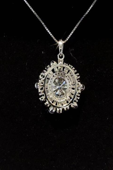 a necklace with a white diamond in the center