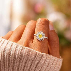 a close up of a person's hand with a ring on it