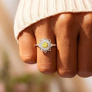 a close up of a person's hand with a ring on it