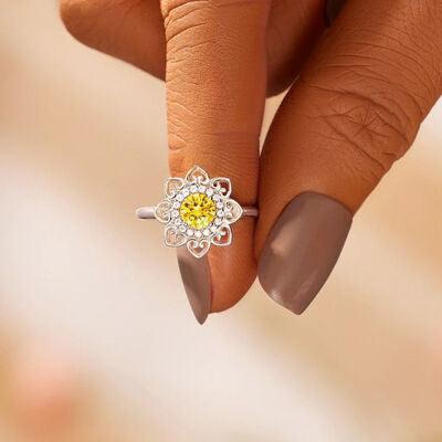 a close up of a person's hand holding a ring