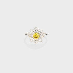 a yellow and white diamond ring on a white background