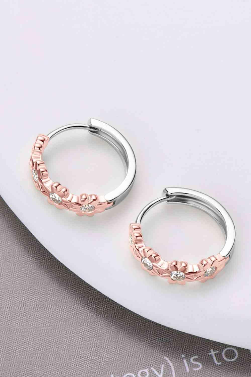 a pair of silver and rose gold hoop earrings