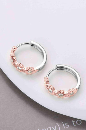 a pair of silver and rose gold hoop earrings