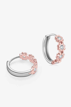 a pair of silver and rose gold hoop earrings