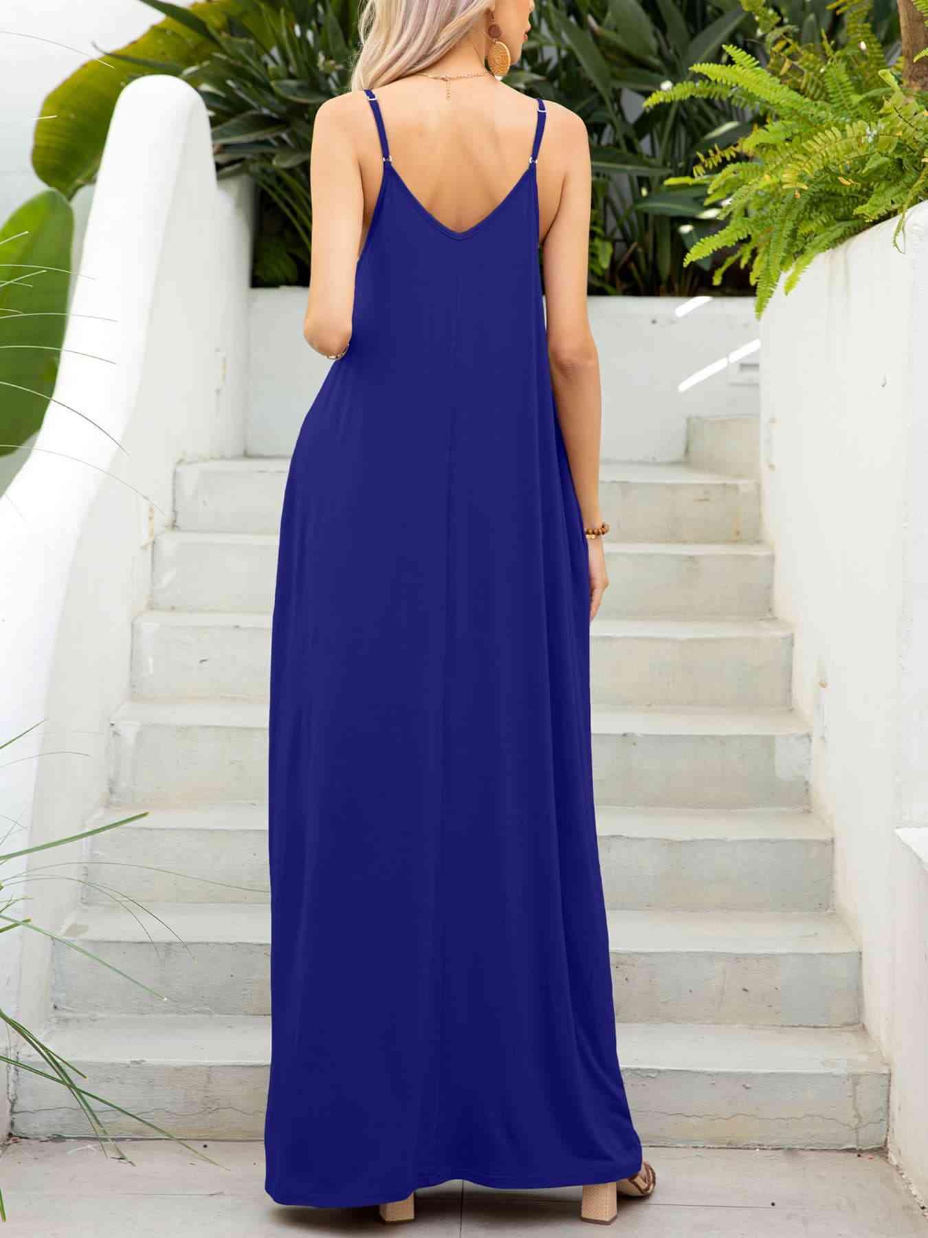 a woman in a blue dress standing on steps