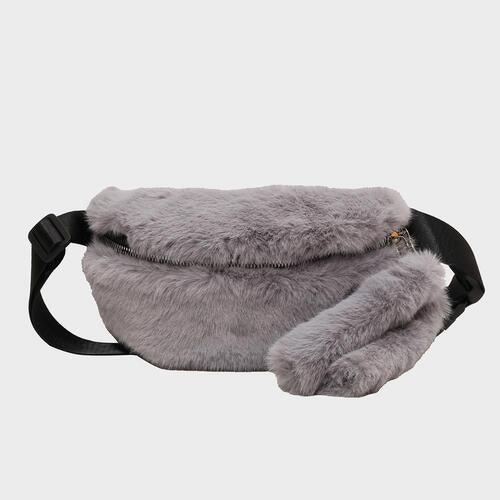 a gray furry bag with a black strap