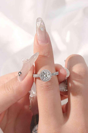 a woman's hand holding a diamond ring