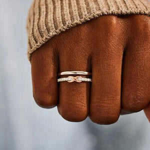 a person's hand with a ring on it