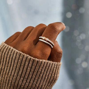 a person's hand with a ring on it