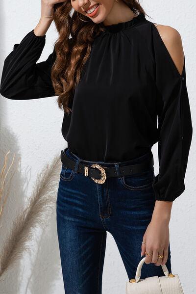 a woman wearing a black top and jeans