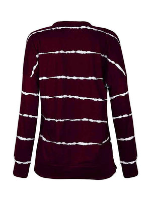 a women's maroon and white striped sweater