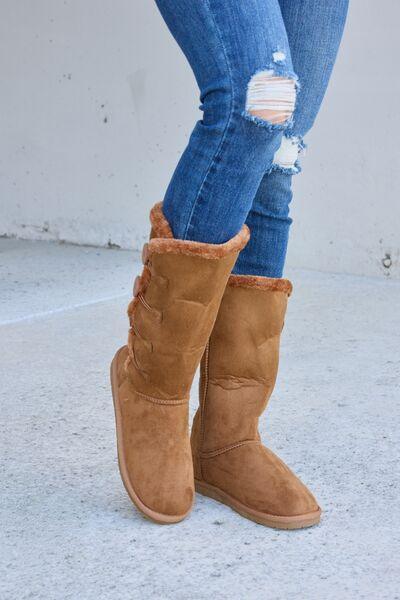 a close up of a person wearing a pair of boots