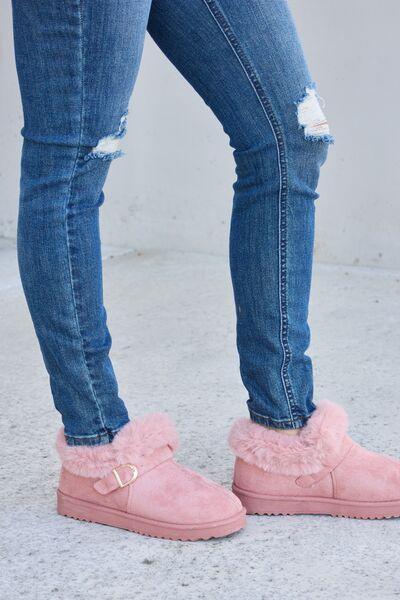 a person wearing pink shoes and jeans