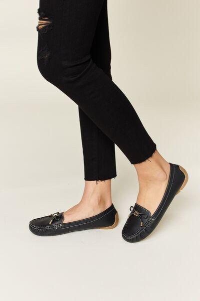 a woman wearing black shoes and black jeans